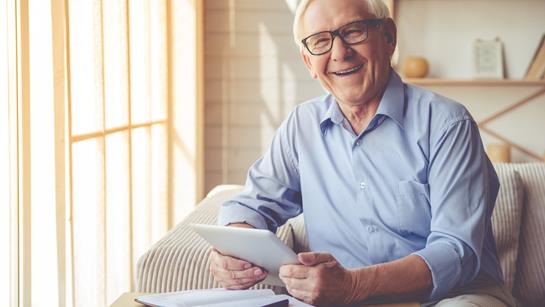 Older Man Happy At Home With Ipad