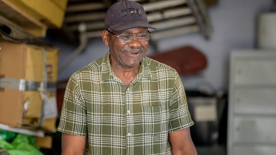 Older Man Smiling At Home In His Garage
